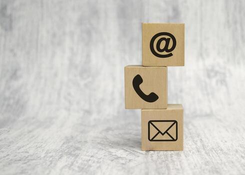 contact-us-concept-with-wood-block-and-symbols-at-e-mail-address-and-phone-free-photo